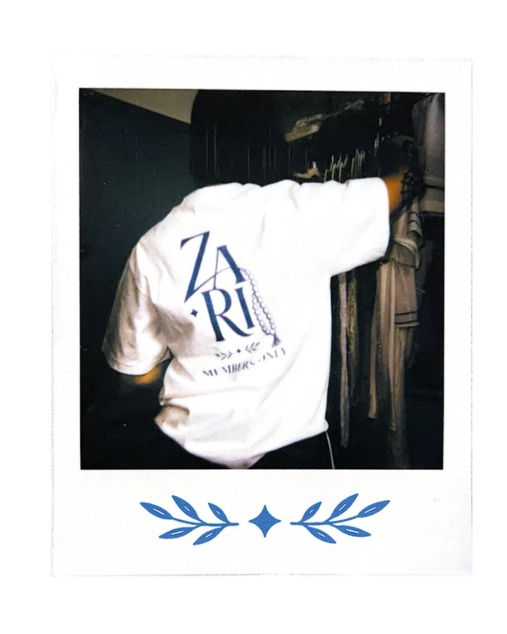 The back print: ZARI over the laurel, MEMBERS ONLY beneath it.
