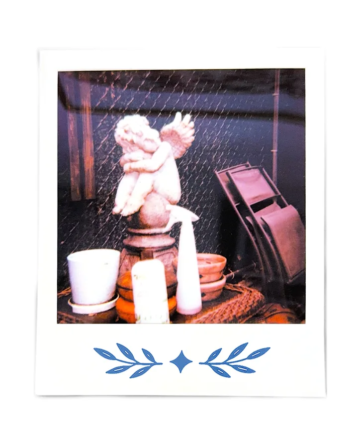 The cherub again, buckets and pots stacked around it.