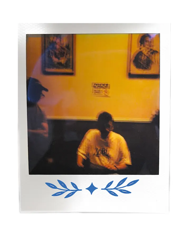 A member in a yellow-lit room, the table gone dark.
